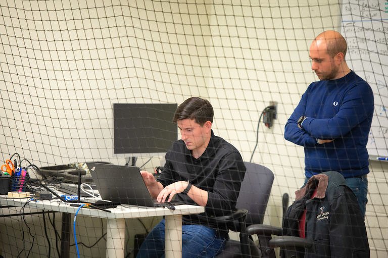Calvin Kielas-Jensen and Venanzio Cichella discuss something on a laptop