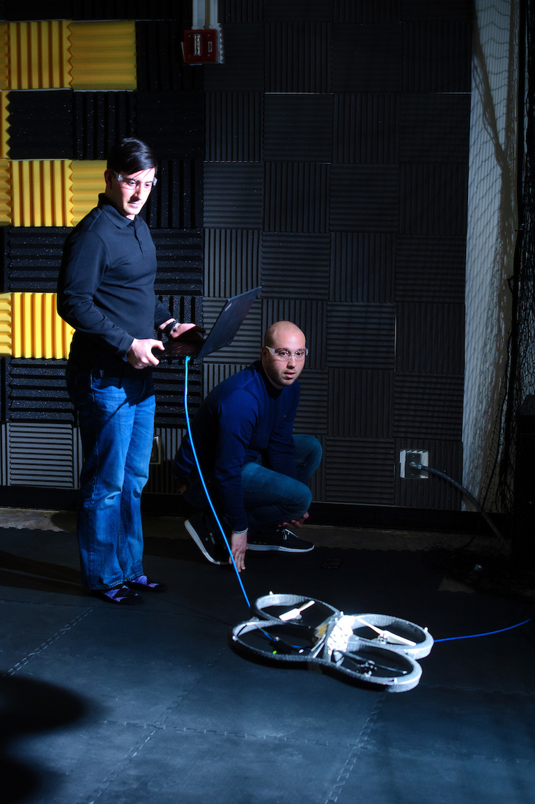 Venanzio Cichella and Calvin Kielas-Jensen work with an autonomous vehicle in the lab