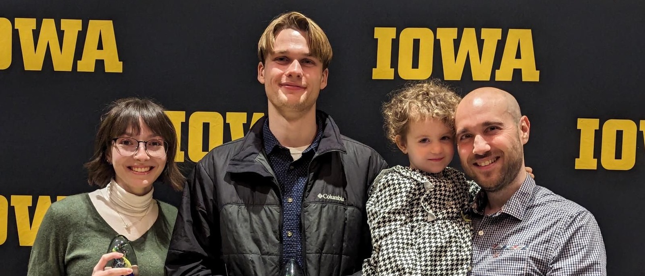 Max and Sabrina pose for a photo with Prof. Cichella and his young child